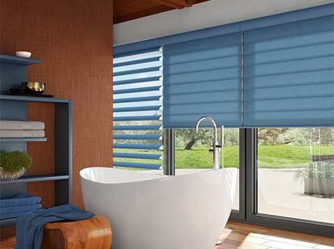 Bathroom with large windows featuring blue shades.